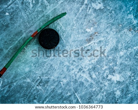 hockey puck and stick on the ice texture, copyspace and text