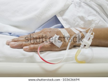Arm of a female patient in the hospital with an IV Royalty-Free Stock Photo #103636694