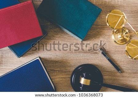 Top view workplace of lawyer with wooden gavel ,judge scale legal and law book on wood table. law and justice legal legislation concept.
