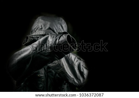Silhouette of a black jacket with a hood. The concept of mystery, incognito.