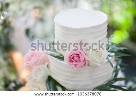 White wedding cake with flowers  Royalty-Free Stock Photo #1036378078