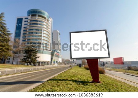 Billboard on the side of the Road against Blurry background