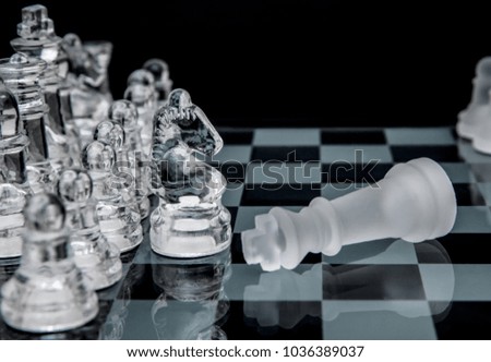 defeated king on a chessboard.glass chess