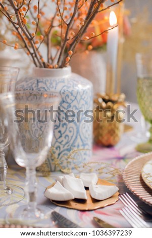 Festive table decor. Many pastel colors. Luxury wedding, party, birthday. Yellow berries. Copper chairs and dishes, gold and silver cutlery.  Chinese, European, chinoiserie style. Peonies and roses.