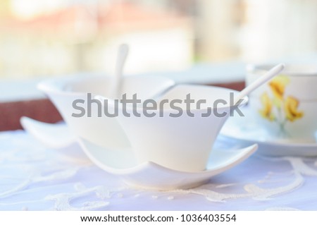 Turkish handmade porcelain tea set with accessories on a balcony table with natural bright day light. 