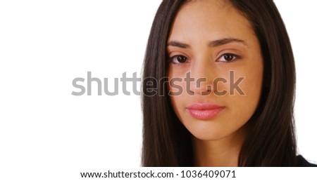 A Hispanic woman poses for a portrait on a white background