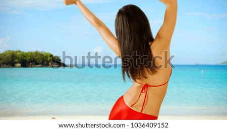 A Hispanic girl plays on the Caribbean beach