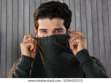 Digital composite of Man against wood with warm jumper
