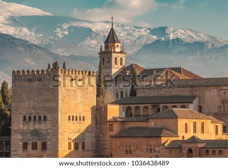 Alhambra palace in Granada with snowy mountains of Sierra Nevada in background, Spain