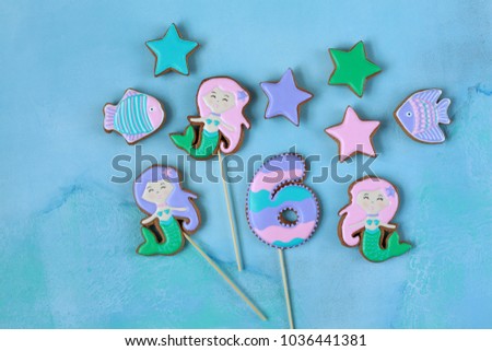 Homemade homemade gingerbread cookies in the shape of a mermaid, fish, stars on a wooden background
