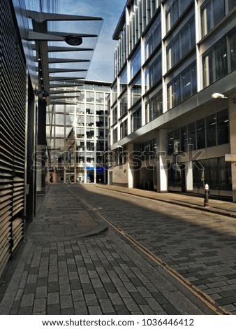 View along empty street of London with modern shopping and business office building