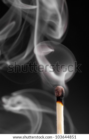 Smoke from a match that was just put out, on the black background