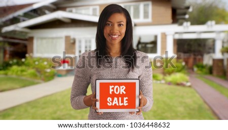 Portrait of cheerful black woman looking for buyer advertising home for sale 