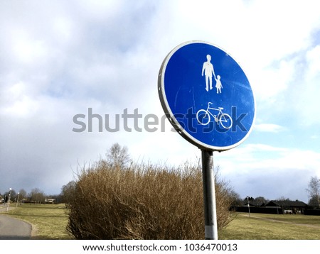 Bicycle and pedestrian signs in community.