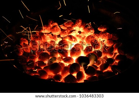 hot briquettes with sparks and fire on grill