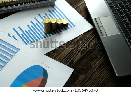 Step of coins stacks with notebook laptop computer and financial graph on white paper on working table, business planning vision and finance analysis concept idea. and copy space for add text.