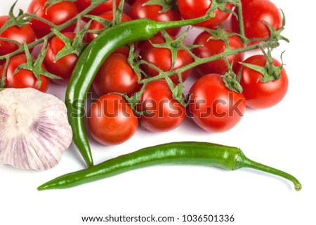 tomatoes, green peppers and other vegetables on a white background.