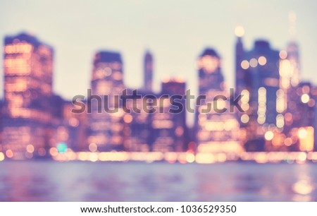 Blurred vintage toned picture of Manhattan skyline at dusk, abstract urban background, New York City, USA.