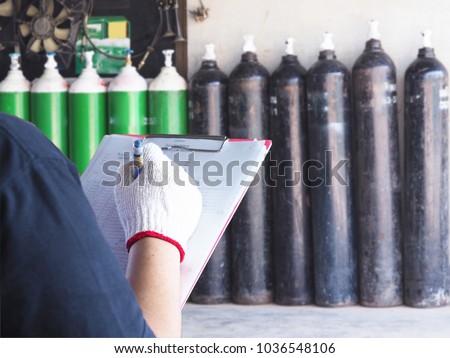 Female technician check Oxygen tank industry Royalty-Free Stock Photo #1036548106