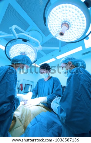 group of veterinarian surgery in operation room take with art lighting and blue filter