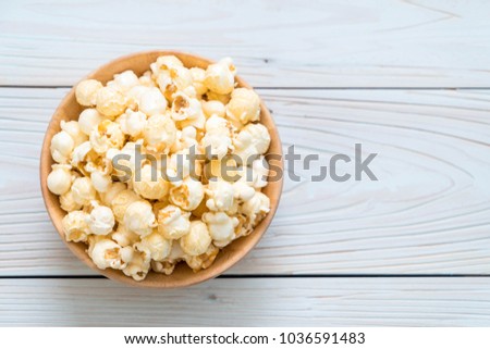 sweet popcorn on wood background