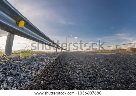 guardrail, is a system designed to keep people or vehicles from straying into dangerous or off-limits areas. Royalty-Free Stock Photo #1036607680