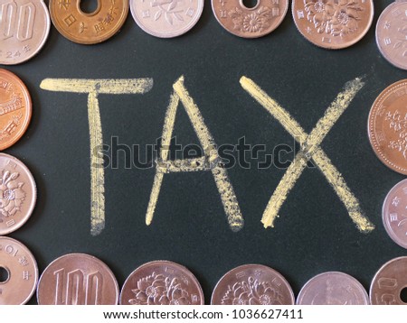 handwriting of  Tax word on chalkboard with the Japanese yen coins 
