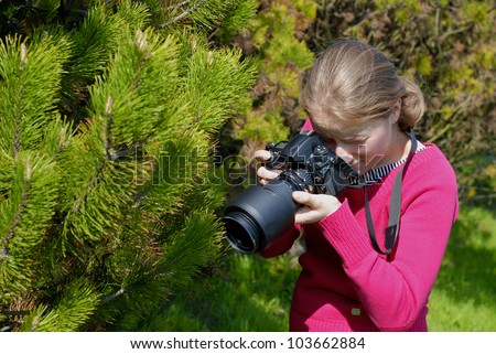professional woman photographer in the park, macro photography