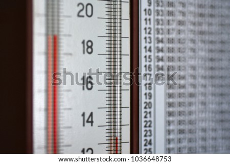 Wall mounted hygrometer thermometer shows a column of temperature and humidity Royalty-Free Stock Photo #1036648753