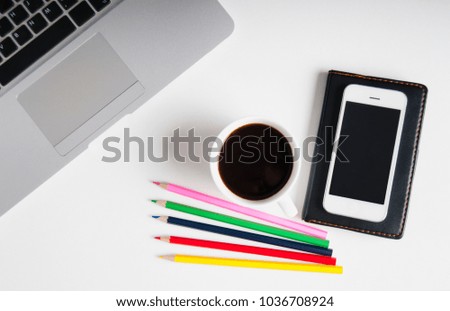 Flat lay on white wooden workspace with laptop computer, cell phone gadget, supplies and black coffee. Deadline concept. Copy space, background, top view.