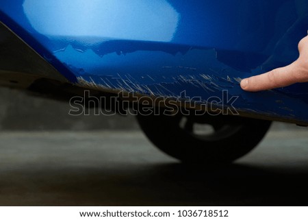 Damaged car paint show man finger close-up