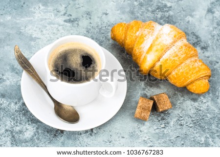 Aromatic hot coffee with croissant for breakfast. Studio Photo