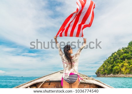 Summer lifestyle freedom traveler woman in bikini joy relaxing holding floating fabric above her head on boat, Andaman sea, Krabi, Travel destination Thailand, Summer holiday outdoor vacation trip