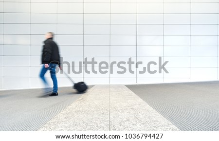 blurred commuters in a modern corridor