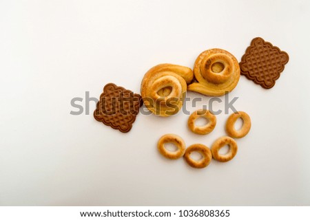 Funny mug laid out of buns and cookies on a white background. Diet