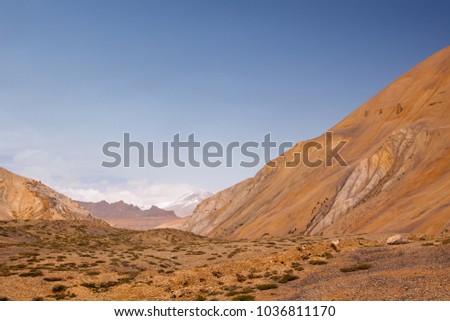 Scenic landscape on himalaya highlands. Valley with golden mountains ans snowy peaks. Kingdom of Ladakh. India.Province State Jammu and Kashmir.