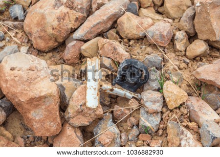 metal part among stones