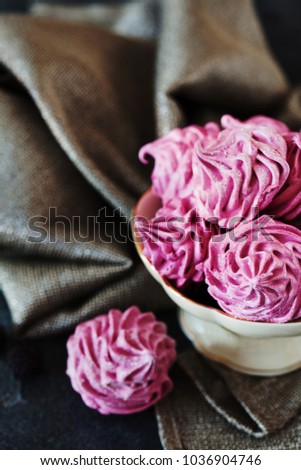 Pink homemade zephyr or marshmallow on dark background. Marshmallow, Meringue, Zephyr