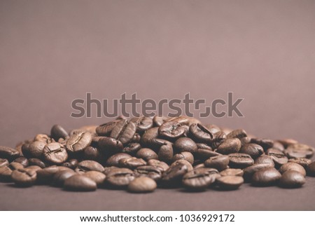 Brown roasted coffee beans on dark background. Espresso dark, aroma, black caffeine drink. copy space.