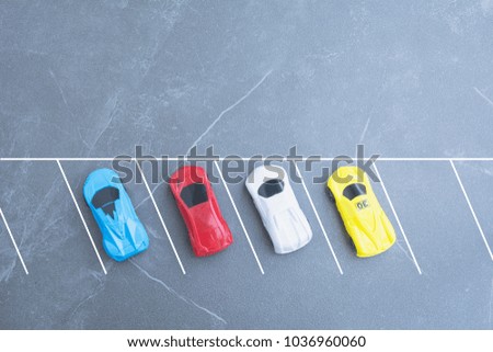 The toy cars parking in car park on background with copy space.