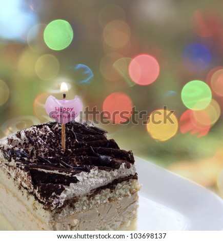 birthday cake with candle against colorful background