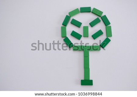  Tree logo concept using wooden green block in white background. 