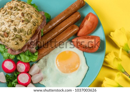 Good morning concept. Fresh vegetables, fried eggs, 
sausages and 
sandwich with bacon and lettuce. Top view image.