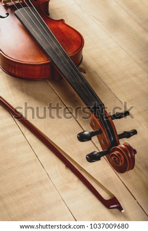 vertical photo of a violin on a table