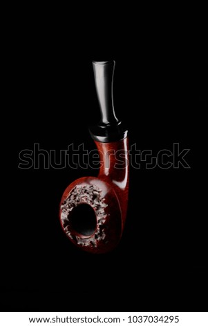 Smoking pipe on black background. Classic bulldog shape of stummel and flawless finishing. Gift for a man idea.