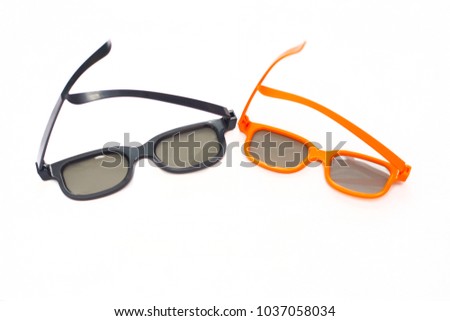 3d glasses in orange and black frames on a white background. View from above