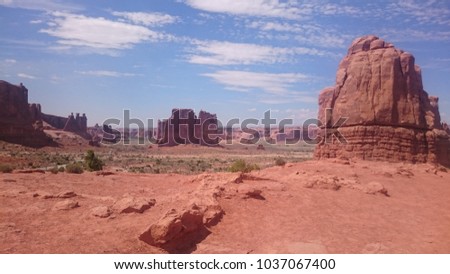 Scenic wild range in Monument Valley Navajo National Park. Ochre dirt over a beautiful Summer Arizona sky.