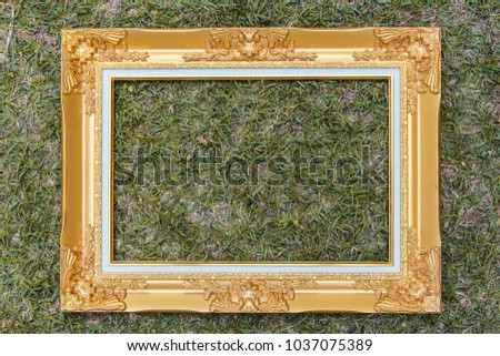 Golden wood frame on green grass background, luxury and nature concept