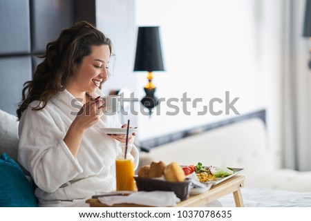 Breakfast in bed, cozy hotel room. concept Royalty-Free Stock Photo #1037078635
