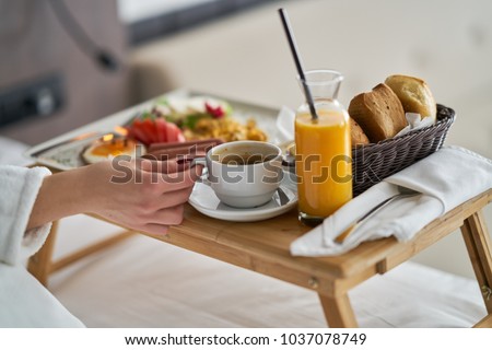 Breakfast in bed, cozy hotel room. concept Royalty-Free Stock Photo #1037078749